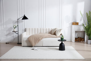 Elevate your living space with the Flora Upholstered Daybed, a stunning blend of modern luxury and functionality. This twin-size daybed is crafted with soft ivory velvet upholstery, offering a lavish, sophisticated look that enhances any room. The ribbed tufted backrest adds an extra layer of elegance, making it the perfect piece for a guest room, living room, or home office.

With the added convenience of 2 built-in drawers, this daybed offers hidden storage to help you keep your space organized. Whether y