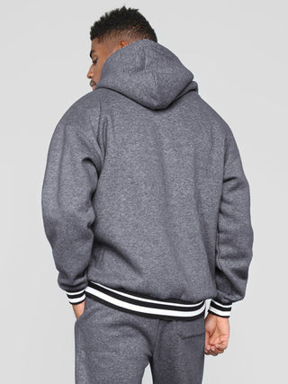 Men? Minimalistic Loose Pullover Hoodie With Front Pocket And A Stripped Hem