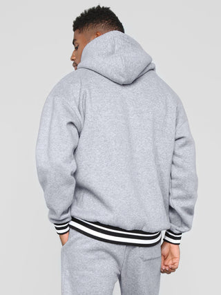 Men? Minimalistic Loose Pullover Hoodie With Front Pocket And A Stripped Hem